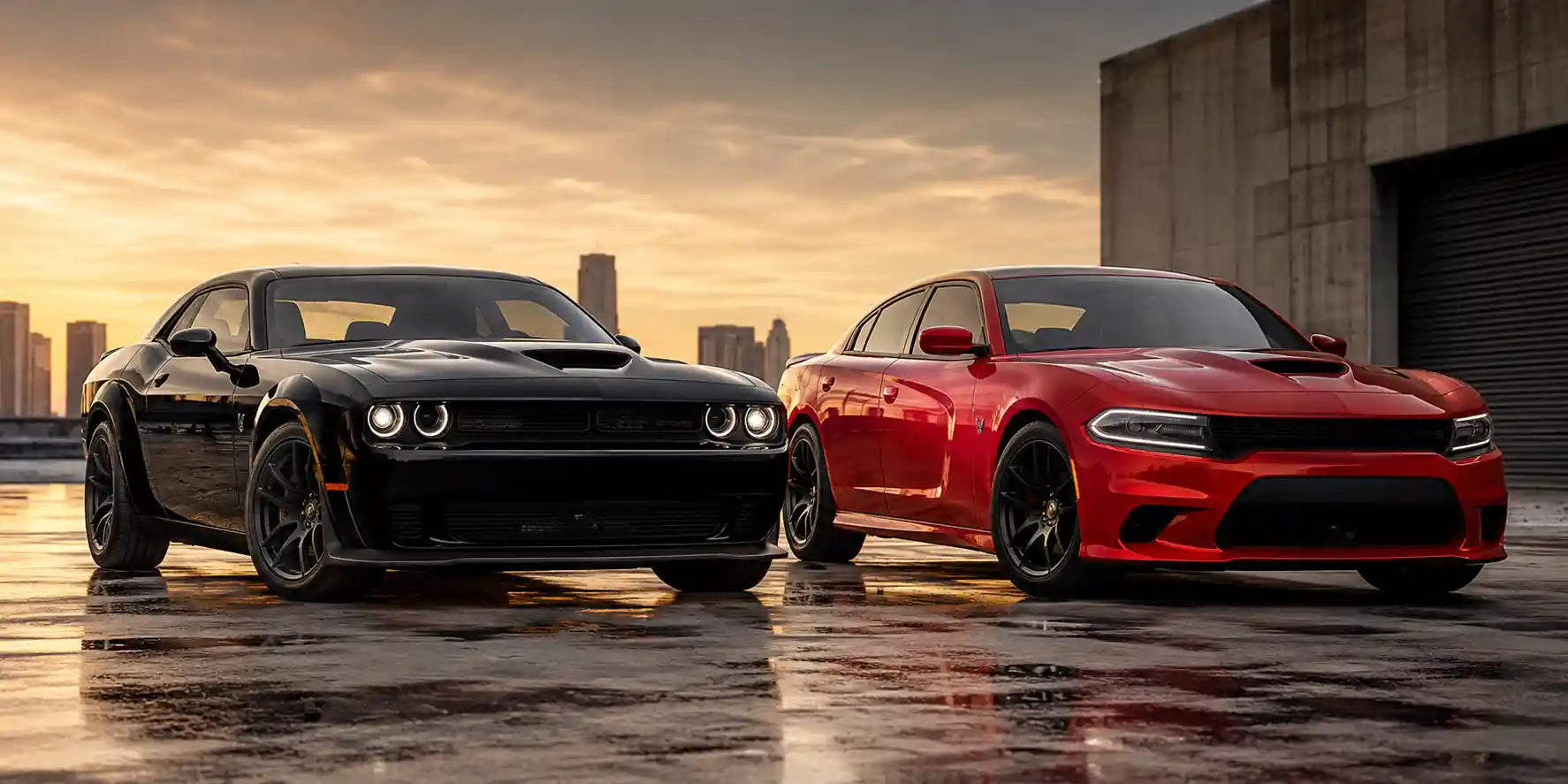 Black Dodge Challenger and Red Dodge Charger parked side by side on a wet concrete surface during sunset with a city skyline in the background.