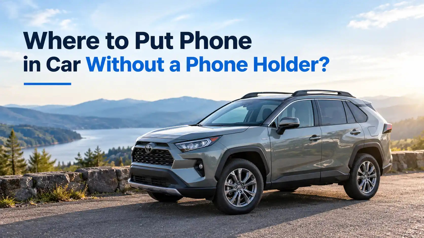 A modern gray Toyota SUV parked on a scenic roadside next to a lake and mountains, with text overlay reading "Where to Put Phone in Car Without a Phone Holder?".