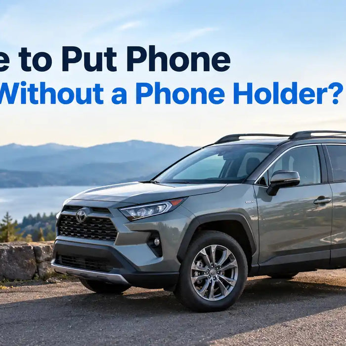 A modern gray Toyota SUV parked on a scenic roadside next to a lake and mountains, with text overlay reading "Where to Put Phone in Car Without a Phone Holder?".