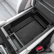 Installed armrest storage tray inside vehicle center console